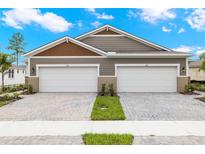 Two-story home with a double garage and landscaped yard at 6161 Timberdale Ave, Wesley Chapel, FL 33545
