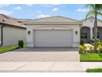 Two-car garage with paver driveway at 4906 Avila Lakes Dr, Wimauma, FL 33598