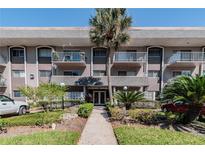 Condo building with entrance and landscaping at 4611 W Fig St # 304, Tampa, FL 33609
