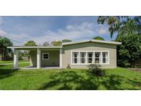 Charming single story home with covered porch and well-manicured lawn at 20605 Preston Ln, Lutz, FL 33558