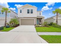 Two-story home with a neutral color palette and a two-car garage at 5472 Summer Sunset Dr, Apollo Beach, FL 33572