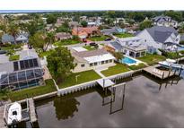 Waterfront property boasts private dock, pool, and lush landscaping at 8716 Elmwood Ln, Tampa, FL 33615