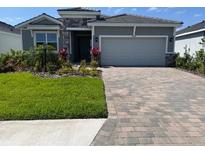 Beautiful single-Gathering home featuring a two-car garage and well-maintained landscaping at 18142 Beach Ranch Ter, Lakewood Ranch, FL 34211