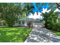 Charming single-story home with mature landscaping, a well-manicured lawn, and a private driveway at 3203 W San Luis St, Tampa, FL 33629