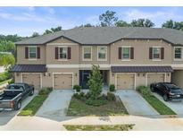 Three townhouses with garages and landscaping at 8491 Essington St, New Port Richey, FL 34654