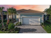 Stunning curb appeal with a two-car garage and landscaped yard at 4838 Sevilla Shores Dr, Wimauma, FL 33598
