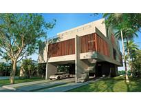 Modern home with concrete exterior and attached garage at 1725 Gulf Rd, Tarpon Springs, FL 34689
