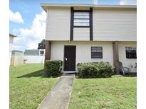 Two-story townhouse with a simple exterior and small lawn at 2017 Pine Chace Ct, Tampa, FL 33613