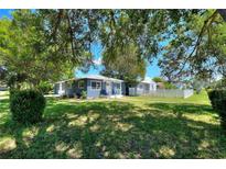 Charming single-story home with a lush green lawn and mature trees providing shade at 3763 Dartmouth N Ave, St Petersburg, FL 33713