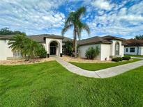 One-story home with a welcoming front porch and lush landscaping at 12384 Creek Edge Dr, Riverview, FL 33579