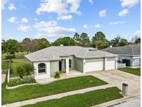 Charming single-story home features a well-manicured lawn and a three-car garage at 13102 Prestwick Dr, Riverview, FL 33579