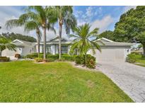 Single-story home with a landscaped yard, driveway, and attached garage at 902 Mcdaniel St # 1, Sun City Center, FL 33573