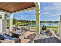 Spacious patio overlooking a lake with wicker furniture at 4790 Snook Se Dr, St Petersburg, FL 33705
