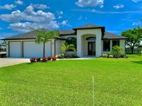 Beautiful new construction home with a two-car garage and lush landscaping at 7101 N Plum Tree, Punta Gorda, FL 33955