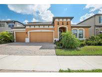 Two-story house with a two-car garage, and a nicely landscaped yard at 12818 Boggy Creek Dr, Riverview, FL 33579