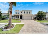 Two story home with landscaped yard and paver driveway at 12334 Blue Pacific Dr, Riverview, FL 33579