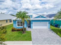 Light blue single-Gathering house with a white garage door at 567 Bimini Bay Blvd, Apollo Beach, FL 33572