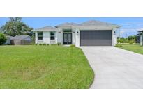 Modern home exterior with two-car garage and manicured lawn at 6999 Burnsville St, Englewood, FL 34224