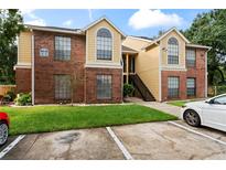 Brick condo building with attractive landscaping and ample parking at 8638 Fancy Finch Dr # 201, Tampa, FL 33614