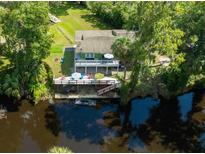 Stunning waterfront home with a spacious deck and lush landscaping at 4617 John Moore Rd, Brandon, FL 33511