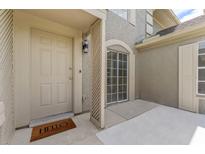 Tan house with a tan door and sliding glass door at 14046 Trouville Dr, Tampa, FL 33624