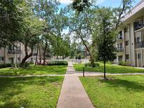 Landscaped community courtyard with walkways at 4606 W Gray St # 110, Tampa, FL 33609