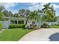 Charming light blue house with lush landscaping at 608 Armada S Rd, Venice, FL 34285