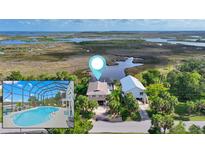 Waterfront home with a screened pool and marsh views for serene coastal living at 4031 Eagle Nest Dr, Hernando Beach, FL 34607
