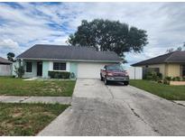 House exterior with a teal exterior and attached garage at 1205 Windhorst Ridge Dr, Brandon, FL 33510