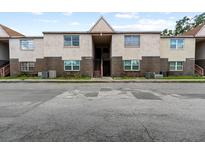 Exterior view of a two-story apartment building with brick and stucco at 9009 Westchester Cir # B-18, Tampa, FL 33604