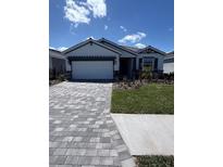 Charming single-story home with a paver driveway and a two-car garage at 18146 Beach Ranch Ter, Lakewood Ranch, FL 34211