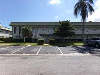 Front view of a light green building with parking in front at 1433 S Belcher Rd # A8, Clearwater, FL 33764