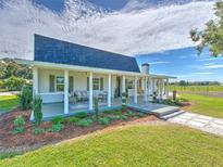 Charming farmhouse with a large front porch at 4608 Holbrook Rd, Plant City, FL 33565