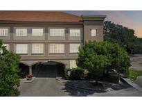 Three-story building with arched entryway and landscaping at 2331 W Horatio St # 610, Tampa, FL 33609
