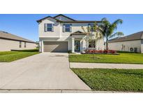 Two-story home with attached garage and landscaping at 3172 Lytton Hall Dr, Zephyrhills, FL 33540