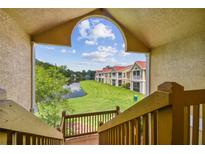 View of the community with lake and lush green landscape from condo stairs at 9481 Highland Oak Dr # 1615, Tampa, FL 33647