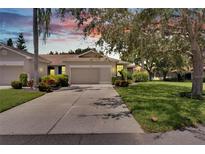 Attractive villa with two-car garage and manicured landscaping at 1015 Radison Lake Ct # 65, Sun City Center, FL 33573