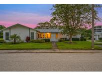 Inviting single story home with a well manicured lawn at 1305 Whitebridge Dr # A, Palm Harbor, FL 34684