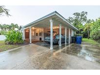 Covered carport with space for one car and additional storage at 1837 Worrington St, Sarasota, FL 34231