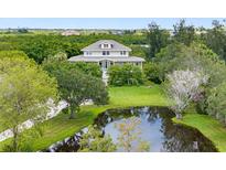 Charming two-story home with pond and lush landscaping at 1215 Bayshore Dr, Terra Ceia, FL 34250
