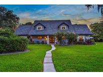 Two-story home with gray siding and a brick walkway at 1810 S Valrico Rd, Valrico, FL 33596