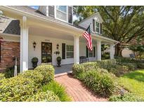 Charming two-story home with a welcoming front porch at 1506 S Sheridan Forest Dr, Tampa, FL 33629