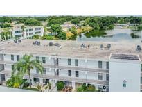 Exterior view of a condo building overlooking a lake at 1655 S Highland Ave # J390, Clearwater, FL 33756