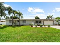 Charming ranch home with well-manicured lawn and landscaping at 5805 8Th Avenue W Dr, Bradenton, FL 34209