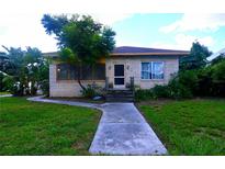 Brick ranch home with a walkway and landscaped yard at 14141 11Th St, Dade City, FL 33525