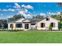 Farmhouse style home with white siding, brown accents, and manicured lawn at 0 Castlewood Rd # Lot 3, Seffner, FL 33584