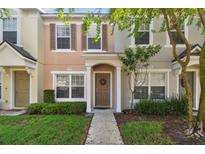 Two story townhome with a brown door and neutral colors at 4538 Kennewick Pl, Riverview, FL 33578
