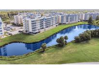 Aerial view of a condo community with lake and lush landscaping at 960 Starkey Rd # 7506, Largo, FL 33771