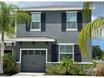 Two-story home with gray siding and a two-car garage at 5525 Twilight Grey Ln, Sarasota, FL 34240