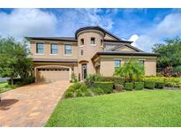 Two-story house with landscaped yard and brick driveway at 2924 Valencia Ridge St, Valrico, FL 33596